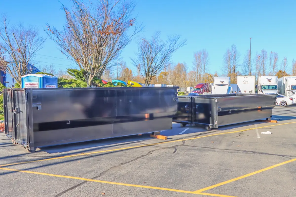 Professional dumpster rental service with roll-off container on residential driveway in Wheaton